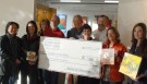 Janice Fong Wolf, Director of Grants & Programs at SLOCCF, presents the grant check to Studios on the Park Board Members